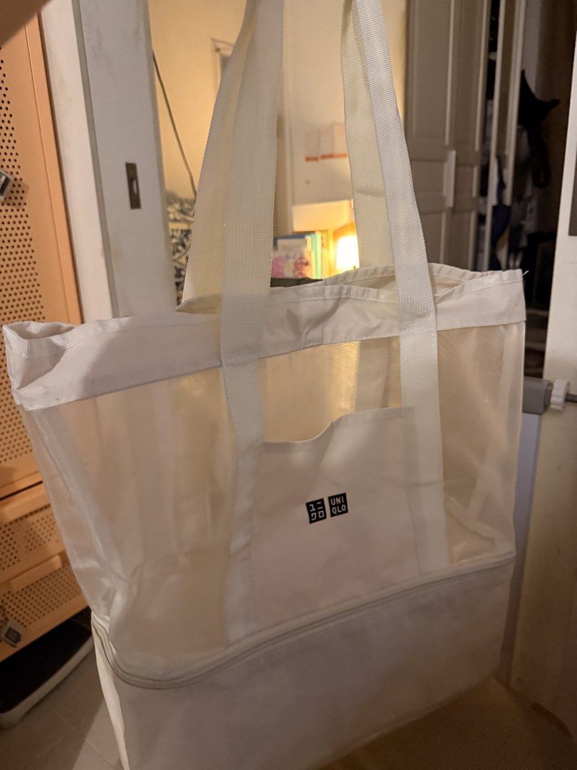 Uniqlo White Mesh Tote Bag With Bottom Compartment (Category: Tote Bags) located in Mandaluyong City. Submitted by ohayouclub (Listing ID 1468854968, Image 1). Description: - Brand: Uniqlo - Color: White - Material: Lightweight and durable mesh - Features: Sturdy top handles for easy carrying - Pocket: Front pocket with Uniqlo logo patch - Compartment: Handy zip compartment at the bottom - Condition: Clean overall.