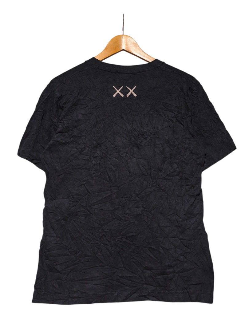UNIQLO x KAWS UT Black Graphic Tee (Category: Shirts) located in Maasim. Submitted by ukayganda25 (Listing ID 1468771002, Image 2). Description: - Brand/Collab: UNIQLO UT x KAWS - Color: Black - Size: Medium (Measures approx. 20.5" x 26") - Material: 100% Cotton, Made in China - Design: Iconic Companion graphic on the front, signature XX logo on the back collar.
