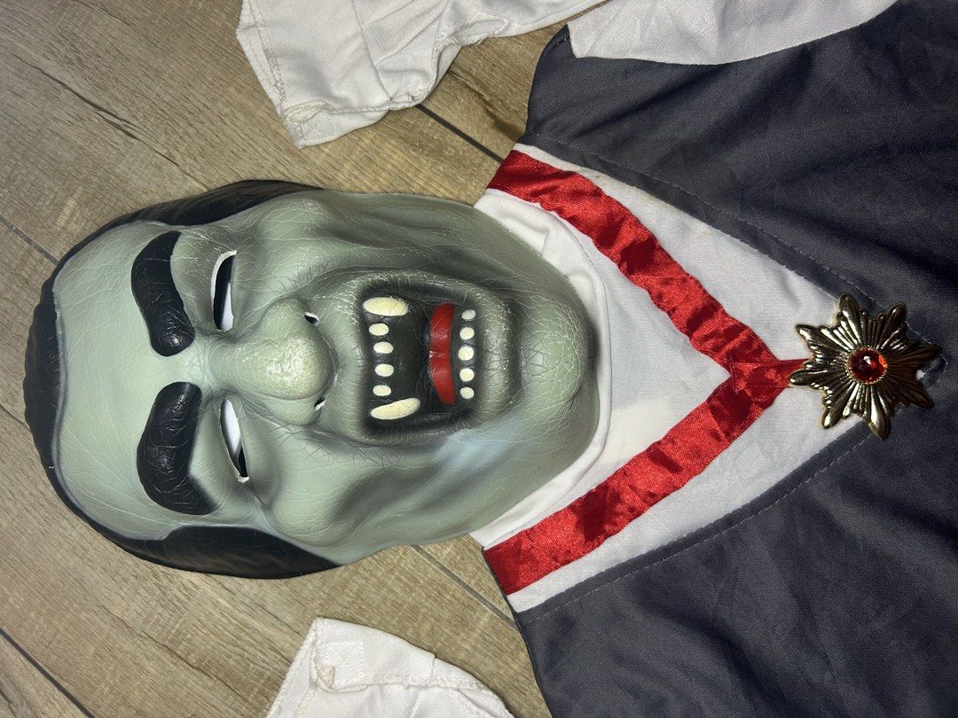 Kids count dracula Vampire Costume (Category: Babies & Kids Fashion) located in Paranaque City. Submitted by zac.sei (Listing ID 1468899471, Image 3). Description: - Vampire costume including top and matching mask - Gray vest-style front with white sleeves and attached red sash - Gold-tone decorative medallion pin with red gem at the neckline - Elastic band on the back of the mask for easy wearing.
