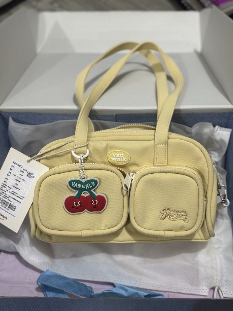 Vanwalk Yellow Cherry Charm Shoulder Bag UNUSED (Category: Shoulder Bags) located in Manila. Submitted by carsonn.y (Listing ID 1468826719, Image 3). Description: UNUSED - Brand: Vanwalk (100% Authentic) - Color: Bright Yellow - Material: Durable canvas with interior lining - Design: Dual top handles, double-zippered main compartment, and two front zipper pockets - Accents: Sweet cherry charm and embroidered script logo on the right pocket - Incl