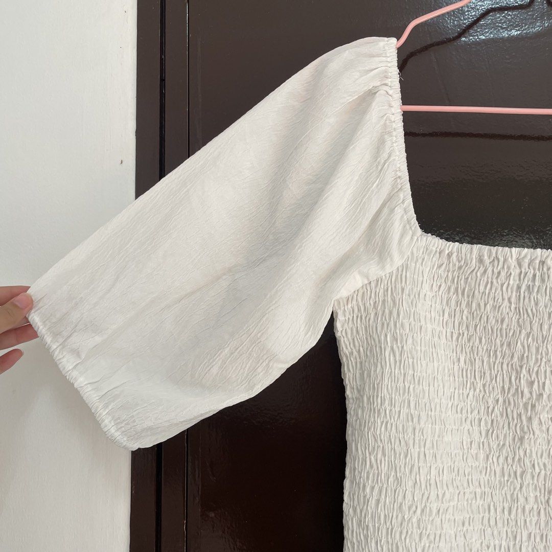 Vero Moda White Smocked Square Neck Top Size S (Category: Blouses) located in Pasay City. Submitted by lovedbyzea (Listing ID 1468783225, Image 2). Description: - Brand: Vero Moda - Color: White - Size: S (fits true) - Design: Square neckline, all-over smocked bodice, half puff sleeves with elastic cuffs, and ruffle hem - Material: Lightweight fabric (Made in India) - Styling: Perfect to pair with denim jeans or skirts.