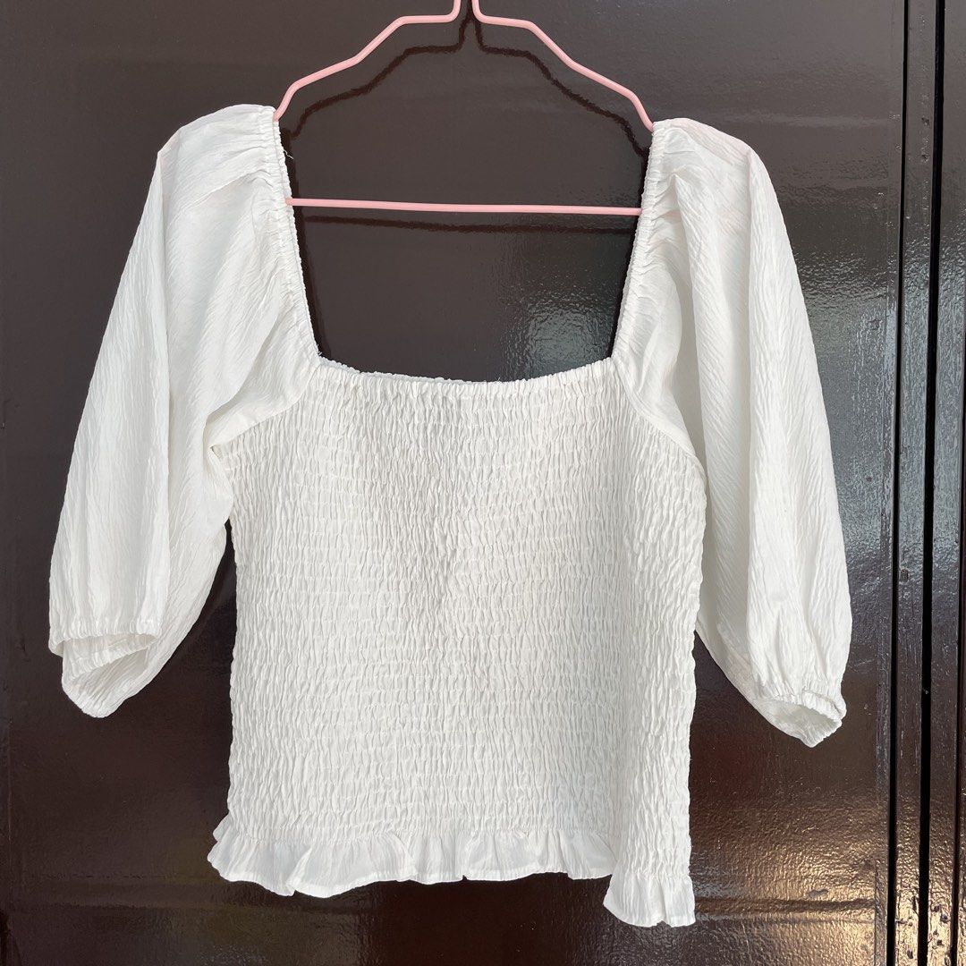 Vero Moda White Smocked Square Neck Top Size S (Category: Blouses) located in Pasay City. Submitted by lovedbyzea (Listing ID 1468783225, Image 1). Description: - Brand: Vero Moda - Color: White - Size: S (fits true) - Design: Square neckline, all-over smocked bodice, half puff sleeves with elastic cuffs, and ruffle hem - Material: Lightweight fabric (Made in India) - Styling: Perfect to pair with denim jeans or skirts.