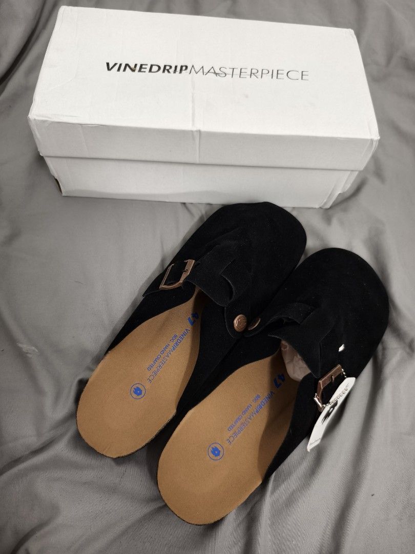 Vinedrip Masterpiece Black Suede Clogs Size 47 (Category: Slippers & Slides) located in Angeles City. Submitted by measaliman02351 (Listing ID 1468744339, Image 1). Description: - Brand: Vinedrip - Model: Masterpiece Clogs - Color: Black - Material: Suede - Size: 47 - Condition: Brand new, never worn, pristine condition - Includes: Original white box and tag attached - Features: Slip-on mule design, adjustable buckle strap, and supportive cork fo