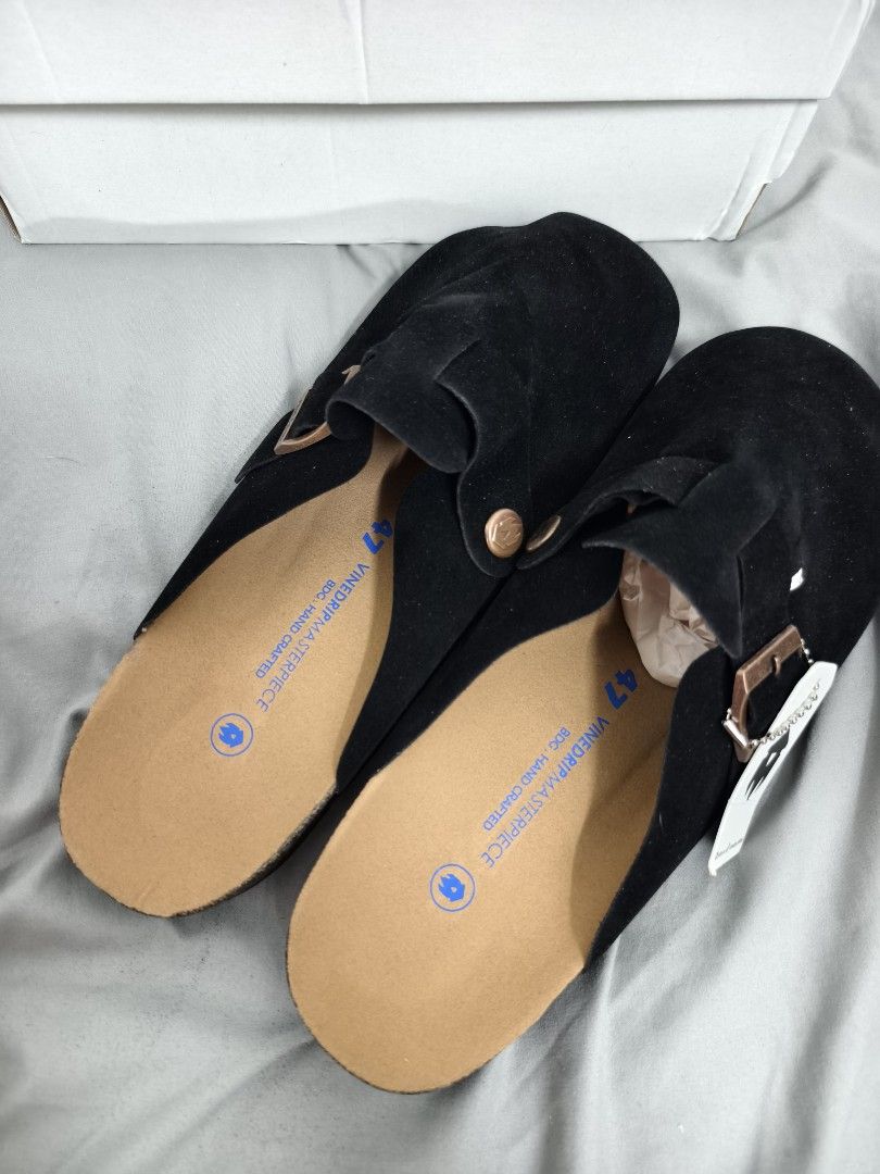 Vinedrip Masterpiece Black Suede Clogs Size 47 (Category: Slippers & Slides) located in Angeles City. Submitted by measaliman02351 (Listing ID 1468744339, Image 3). Description: - Brand: Vinedrip - Model: Masterpiece Clogs - Color: Black - Material: Suede - Size: 47 - Condition: Brand new, never worn, pristine condition - Includes: Original white box and tag attached - Features: Slip-on mule design, adjustable buckle strap, and supportive cork fo