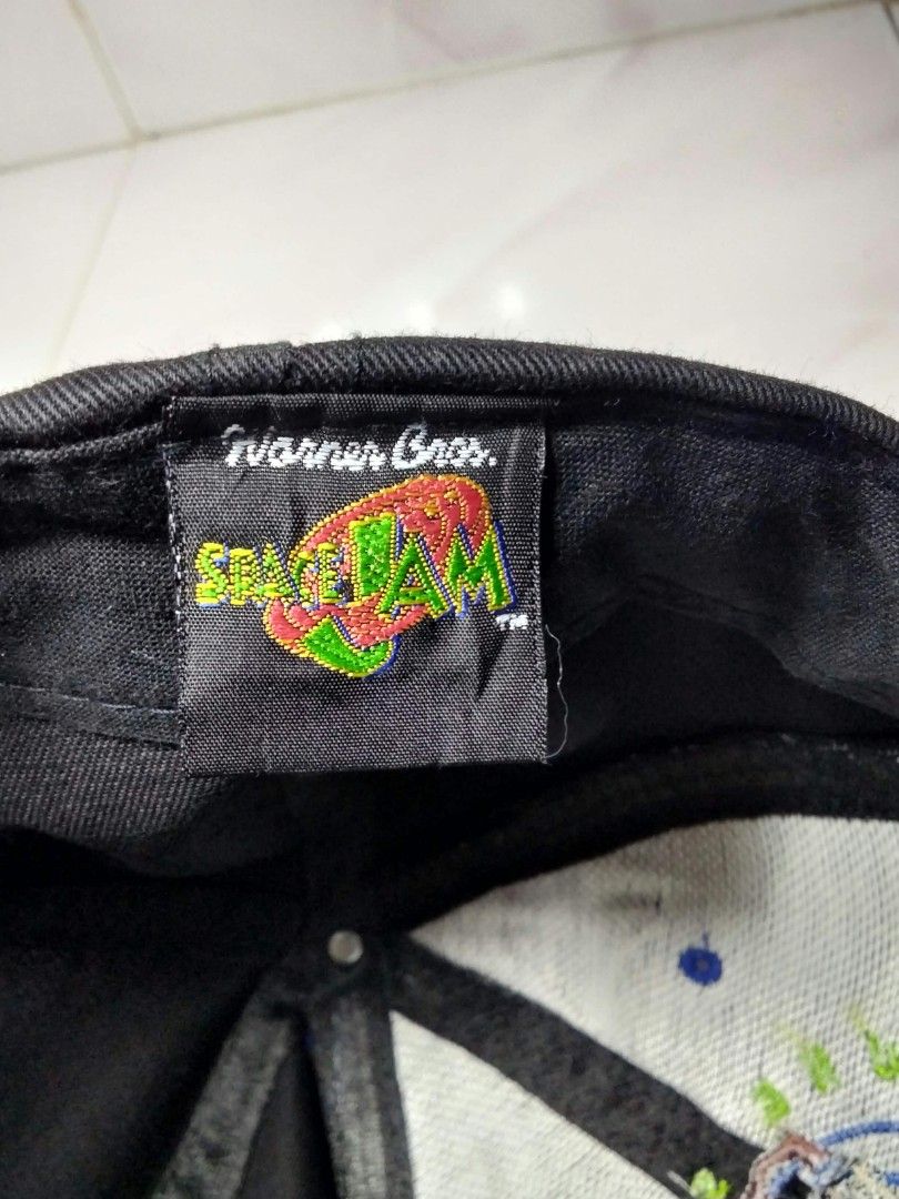 Vintage 1996 Space Jam Taz Tune Squad Snapback Cap (Category: Caps & Hats) located in Aroroy. Submitted by pinaskaboo (Listing ID 1468754927, Image 3). Description: - Vintage 1996 Space Jam snapback by Fresh Caps - Classic black crown with a contrasting royal blue brim - Front features embroidered Tazmanian Devil and Tune Squad lettering - Authentic Warner Bros tag inside - 100% cotton material - One size fits all with adjustable snapback closure