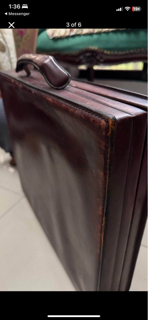 Vintage Brown Leather Briefcase Attache Case (Category: Briefcases) located in Caloocan City. Submitted by BrixGarcia (Listing ID 1468792422, Image 2). Description: - Color: Deep brown - Material: Genuine leather with tan leather lining - Features: Solid top handle, central lock closure, and divided interior document compartments with a securing strap - Condition: Visible scuffs, edge wear, and peeling on the exterior frame, along with age spots 