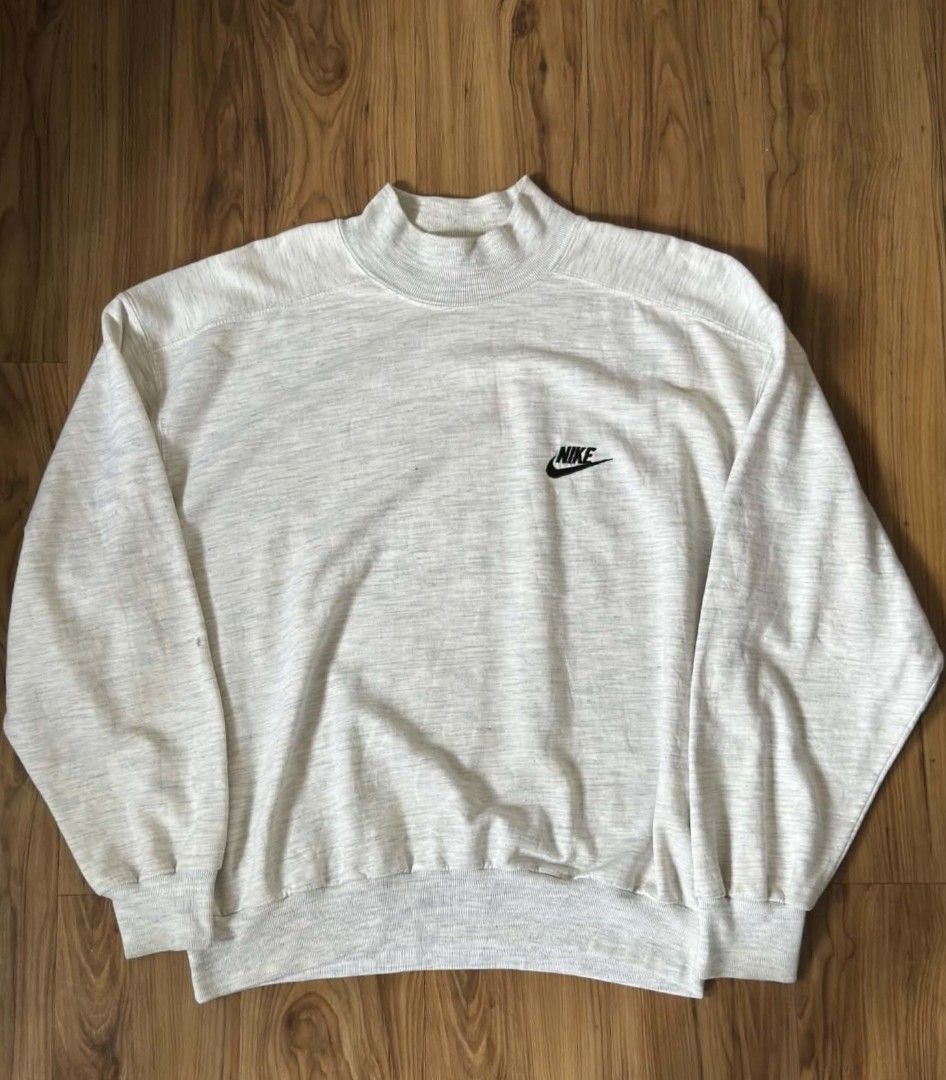 Vintage Nike Mock Neck Grey Sweatshirt (Category: Coats, Jackets and Outerwear) located in Caloocan City. Submitted by jpygoodies (Listing ID 1468787877, Image 1). Description: - Brand: Nike - Color: Light grey marl - Style: Mock neck sweatshirt with relaxed fit & dropped shoulders - Details: Ribbed cuffs & hem, small embroidered black Nike swoosh on chest - Condition: Excellent, comfortable casual wear - Perfect for: Everyday layering and cozy f