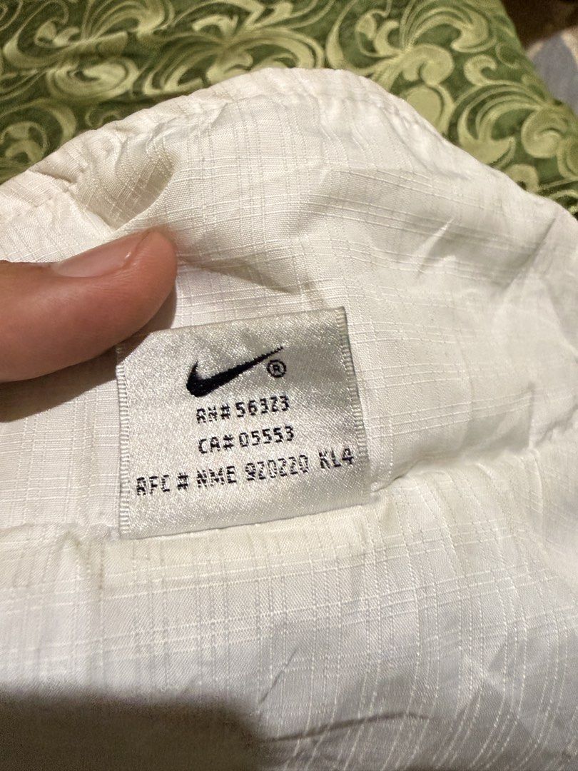 Vintage Nike White Windbreaker Jacket (Category: Coats, Jackets and Outerwear) located in Iriga City. Submitted by shoinkzz (Listing ID 1468787253, Image 3). Description: - Authentic vintage Nike windbreaker in white with dark chest and shoulder accents - Size: Large (tag inside) - Material: Durable nylon outer with breathable mesh lining - Features: Full zip front, high collar, and two front pockets - Details: Iconic Nike branding on the sleeve 