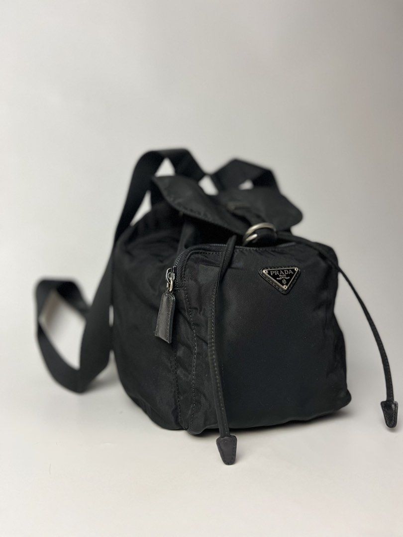 Vintage Prada Tessuto Nylon Mini Backpack (Category: Luxury Bags & Wallets) located in Manila. Submitted by streetsavvy (Listing ID 1468806006, Image 2). Description: Vintage Prada Tessuto Nylon Mini Backpack Width: 7” Height: 10” Depth: 5” Measured in Inches Crafted in Italy from durable nylon with signature Saffiano leather accents and silver-tone hardware featuring the iconic enamel triangle logo on the front zip pocket. Features a drawstring 