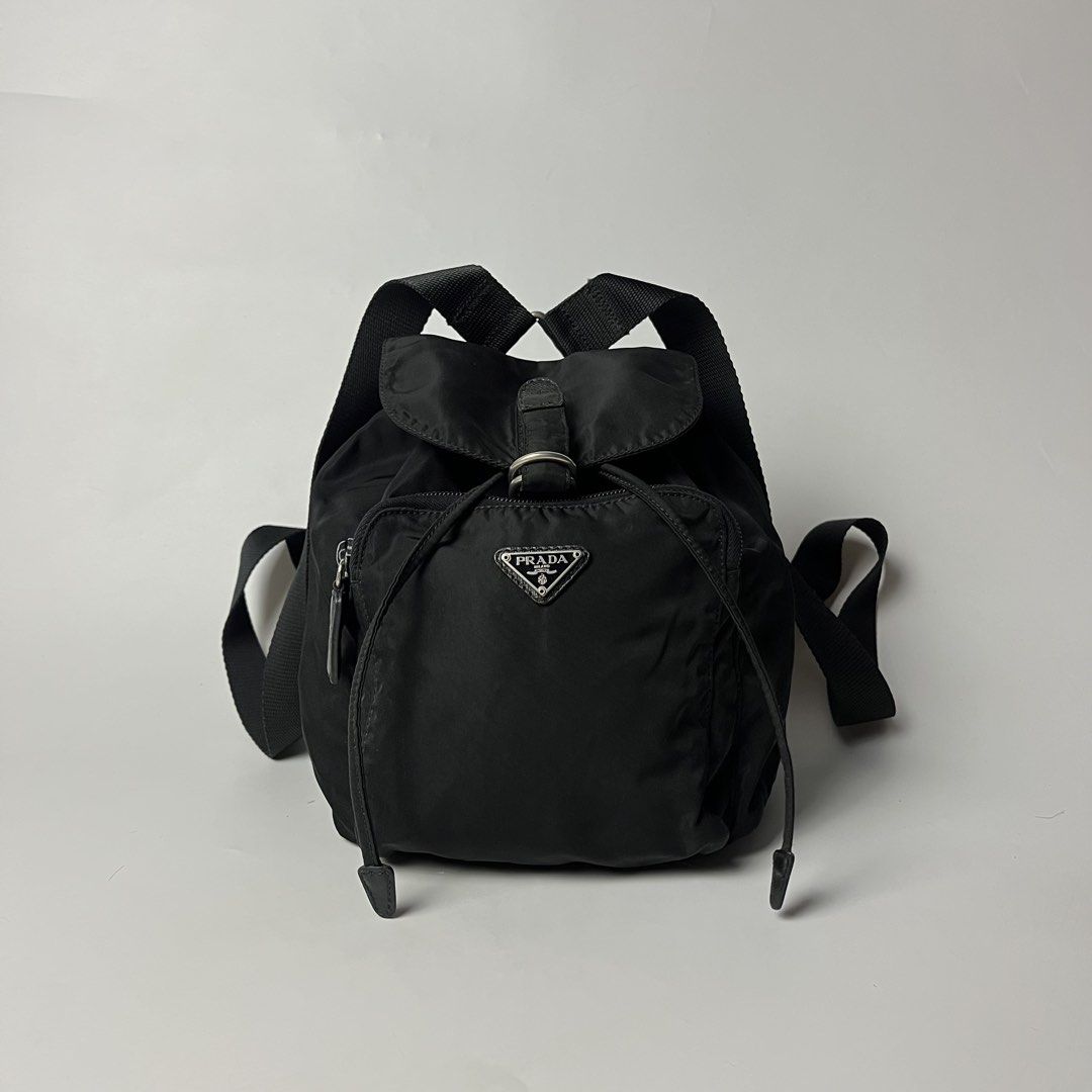 Vintage Prada Tessuto Nylon Mini Backpack (Category: Luxury Bags & Wallets) located in Manila. Submitted by streetsavvy (Listing ID 1468806006, Image 1). Description: Vintage Prada Tessuto Nylon Mini Backpack Width: 7” Height: 10” Depth: 5” Measured in Inches Crafted in Italy from durable nylon with signature Saffiano leather accents and silver-tone hardware featuring the iconic enamel triangle logo on the front zip pocket. Features a drawstring 
