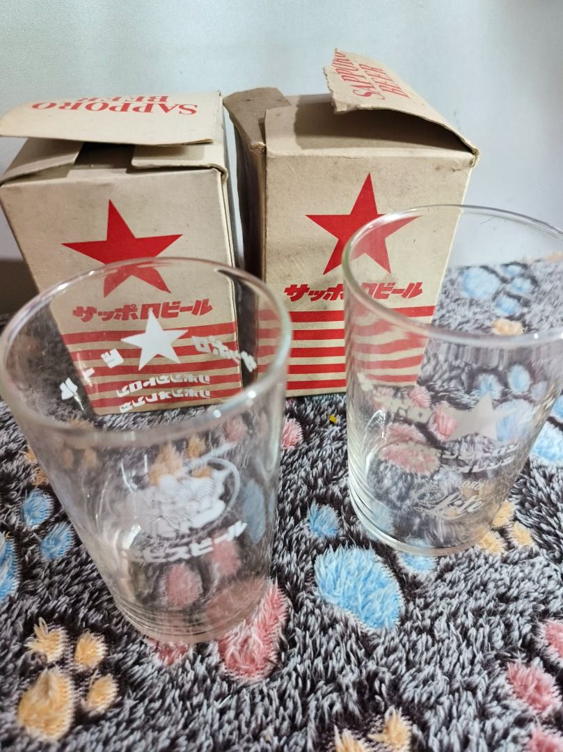 Vintage Sapporo Beer Glasses with Original Boxes (Category: Vintage Collectibles) located in San Leonardo. Submitted by burgossanleonardo.12345 (Listing ID 1468764863, Image 1). Description: - Set of 2 vintage Sapporo beer glasses - Features unique graphic prints: one with the Ebisu deity logo and Japanese text, the other with a star emblem and Sapporo Lite branding - Height: Approx. 11 cm - Includes original cardboard packaging boxes with red st