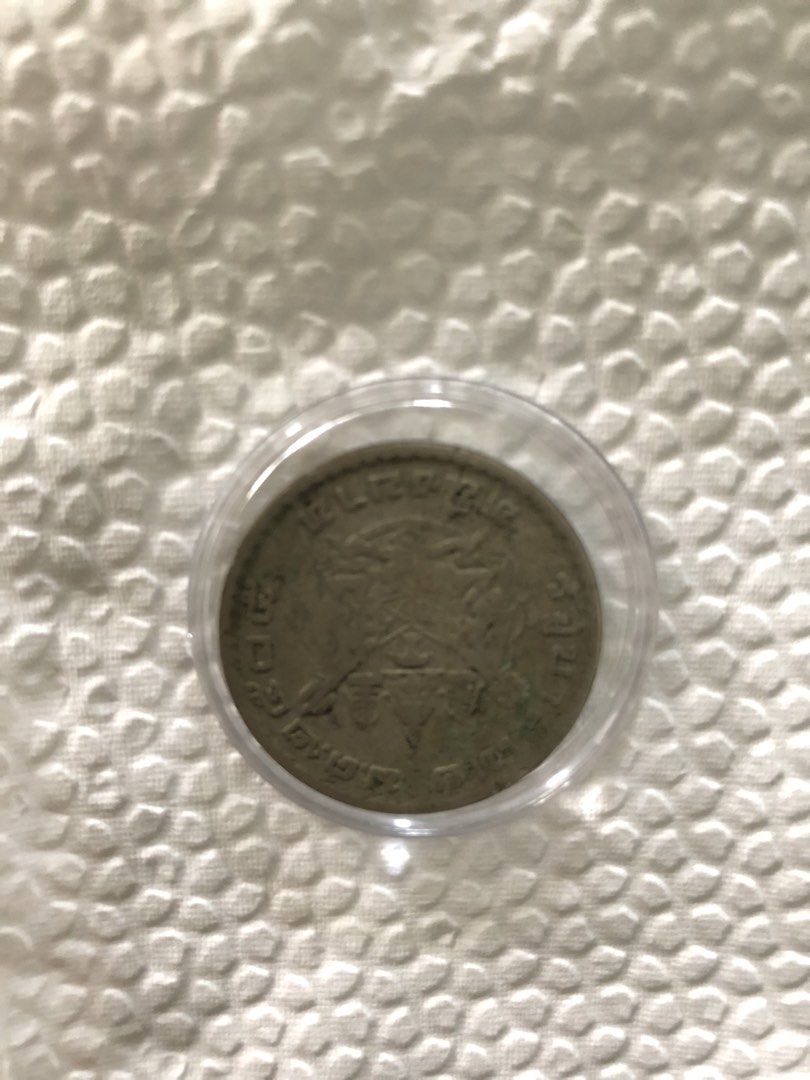 Vintage silver coin in protective capsule (Category: Currency) located in Muntinlupa City. Submitted by jkani (Listing ID 1468754578, Image 3). Description: - Vintage commemorative coin with a detailed portrait on the front and an intricate crest on the reverse - Housed securely inside a clear plastic protective capsule - Displays natural tarnish and authentic patina that adds to its vintage character - Clear and well-preserved details along the 