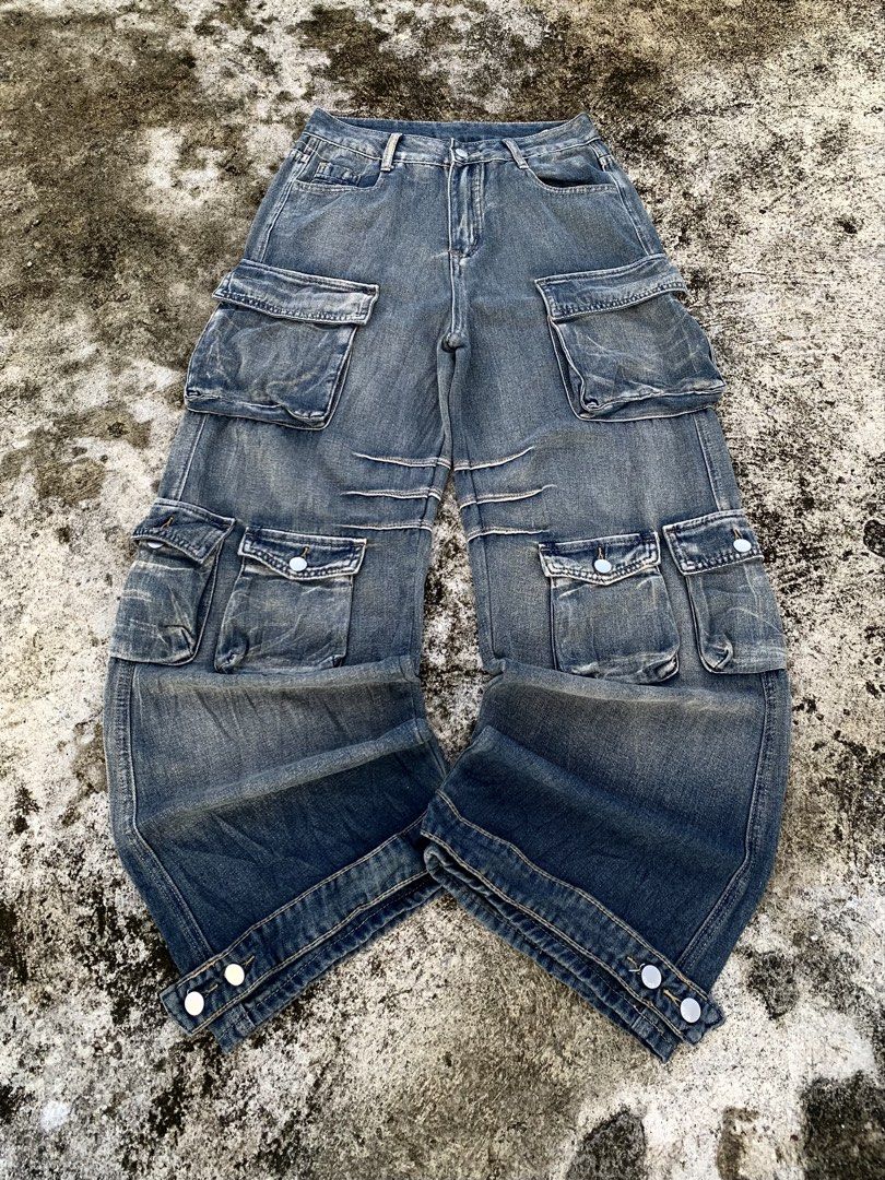 Vintage Wash Multi-Pocket Cargo Jeans (Category: Jeans) located in Manila. Submitted by fiercefox.4ae806 (Listing ID 1468879472, Image 1). Description: - Style: Mid-blue denim cargo jeans with a heavy vintage wash and relaxed streetwear fit - Pockets: Multiple functional flap pockets on thighs and lower legs - Details: Knee pleats and durable contrast stitching throughout - Fit: Adjustable button snaps at the wide cuffs and secure zipper fly with