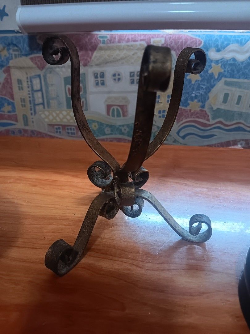 Vintage Wrought Iron Scrollwork Stand Base (Category: Tables & Sets) located in Las Pinas. Submitted by jesus1smysavi0r (Listing ID 1468743920, Image 3). Description: - Material: Solid wrought iron with a dark finish - Design: Elegant scrollwork feet and a sturdy triangular base secured by a central bolt - Condition: Good, solid construction with natural patina from age - Versatility: Heavy and stable, perfect for holding small display items or d