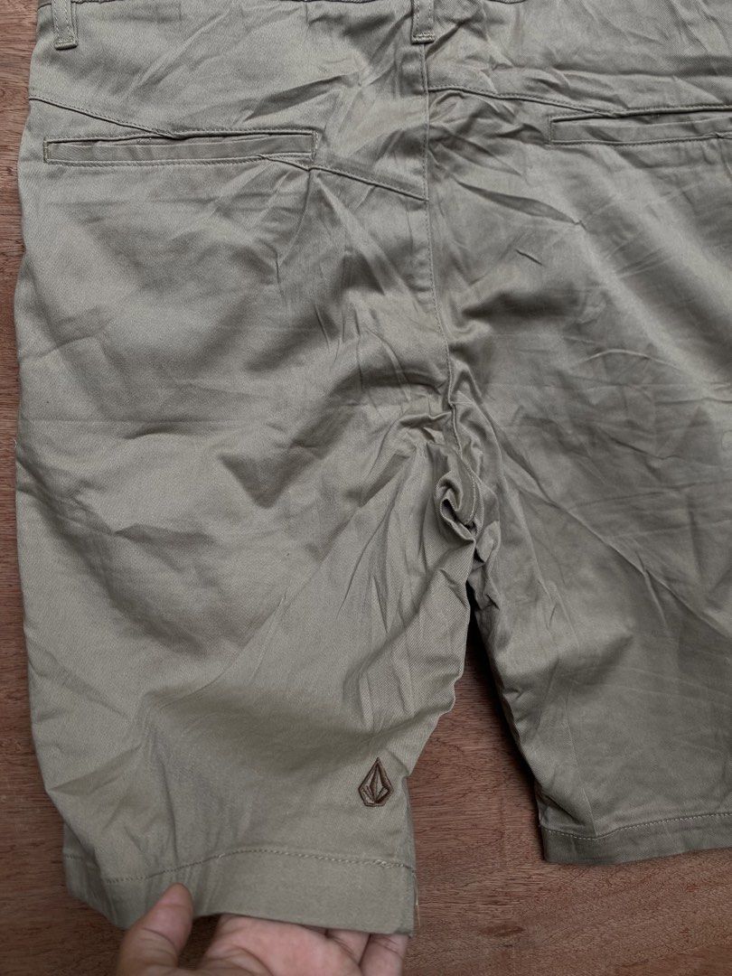 Volcom Chino Shorts Khaki Size 36 (Category: Shorts) located in Puerto Princesa. Submitted by earlpogitrhift (Listing ID 1468771730, Image 3). Description: - Brand: Volcom - Style: Chino Shorts - Color: Khaki Brown - Size: Men's 36 Length 23 - Material: Cotton blend - Details: Button fly closure, front/rear pockets, embroidered Volcom stone logo near hem - Condition: Clean inner lining and waistband tag - Perfect casual everyday staple.