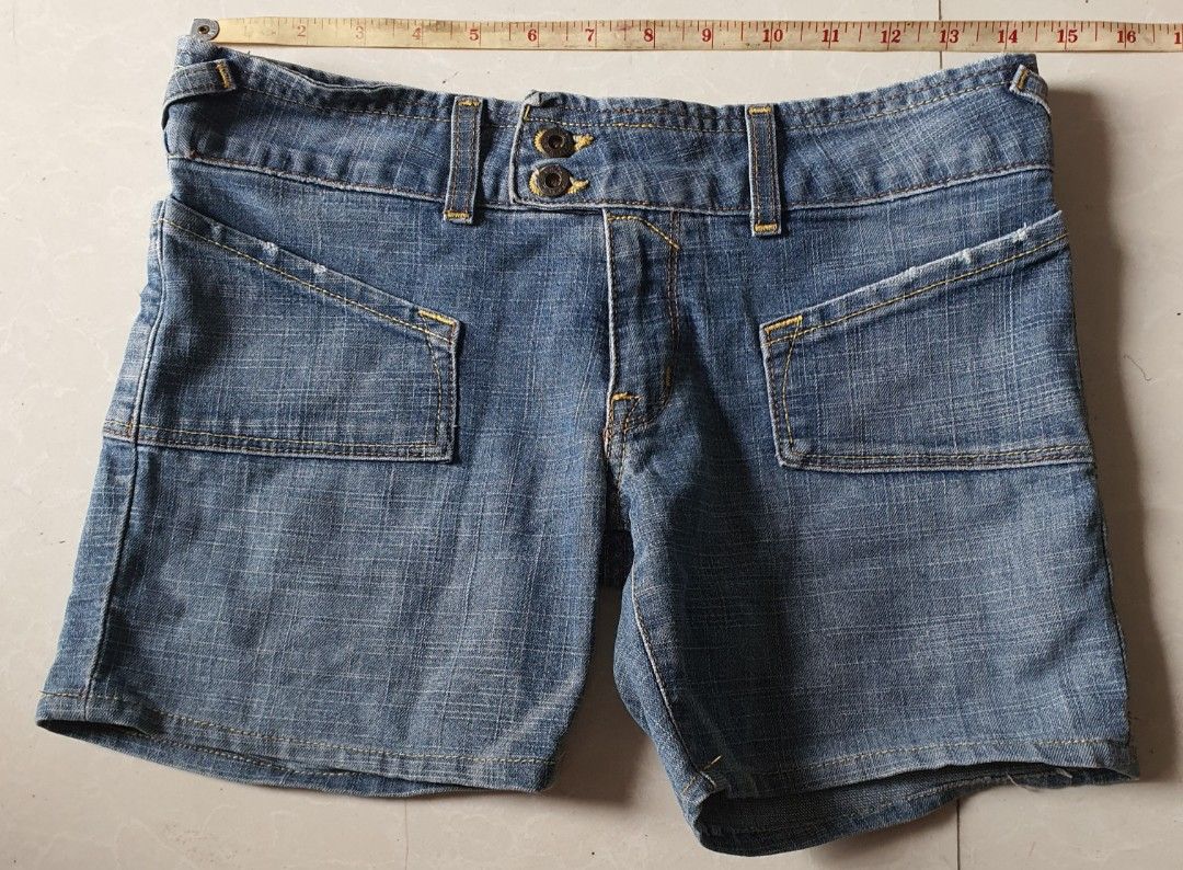 Von Dutch Denim Shorts (Category: Shorts) located in Meycauayan. Submitted by shoptoown (Listing ID 1468749235, Image 2). Description: - Brand: Von Dutch - Style: Classic Y2K denim shorts - Wash: Medium blue with yellow contrast stitching - Waist: ~14 inches across (flat lay) - Details: Double button closure, front pockets, and genuine leather back patch - Condition: Great for casual summer wear.