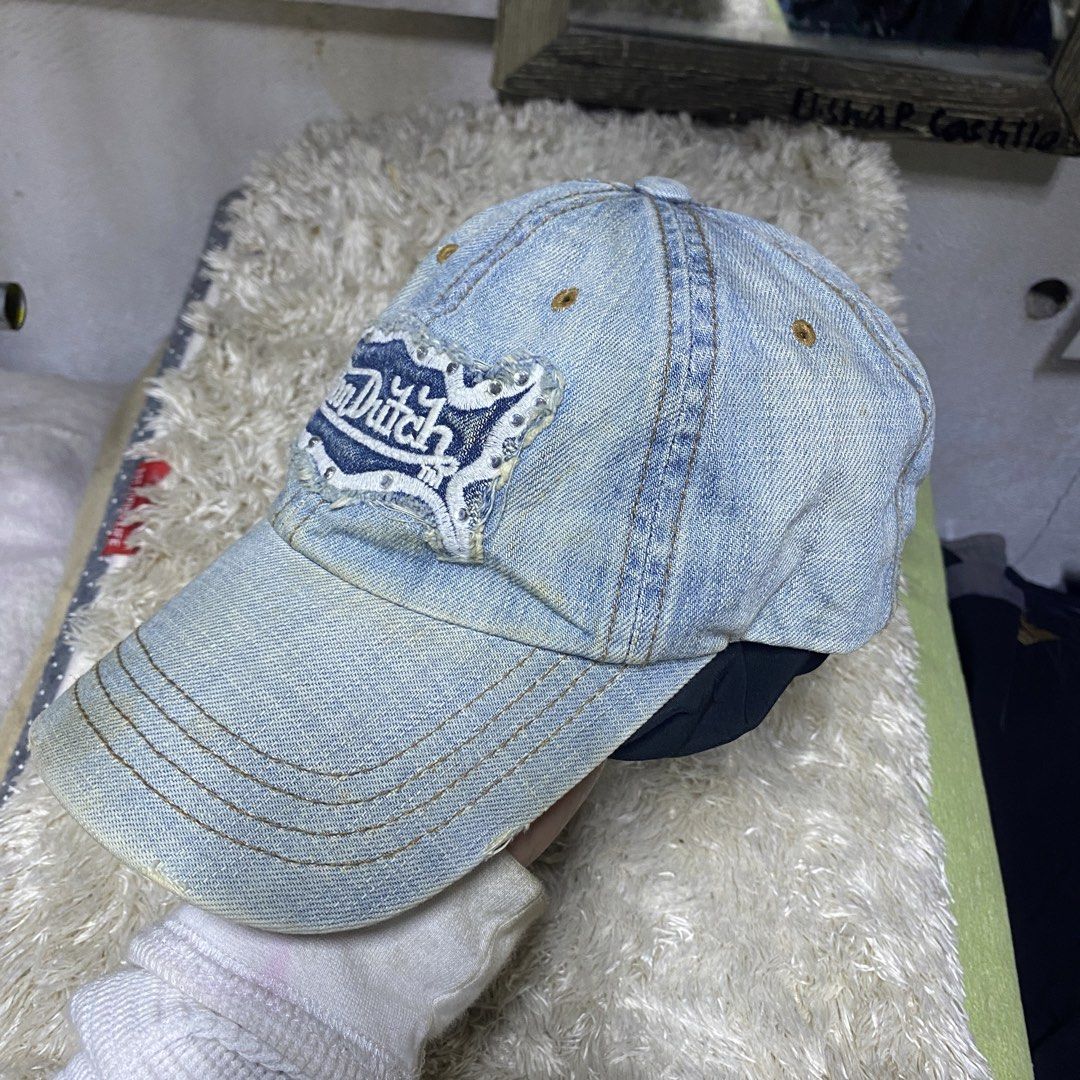Von Dutch Denim y2k Cap (Category: Caps & Hats) located in Cagayan de Oro. Submitted by neoazai (Listing ID 1468817307, Image 2). Description: - Brand: Von Dutch - Style: Classic Y2K baseball cap - Color/Material: Light blue denim - Details: Distressed front patch with rhinestone border - Fit: Adjustable leather strap with metal buckle - Authenticity: Includes Kustommade Originals tag inside - Condition: Brand new / Excellent.