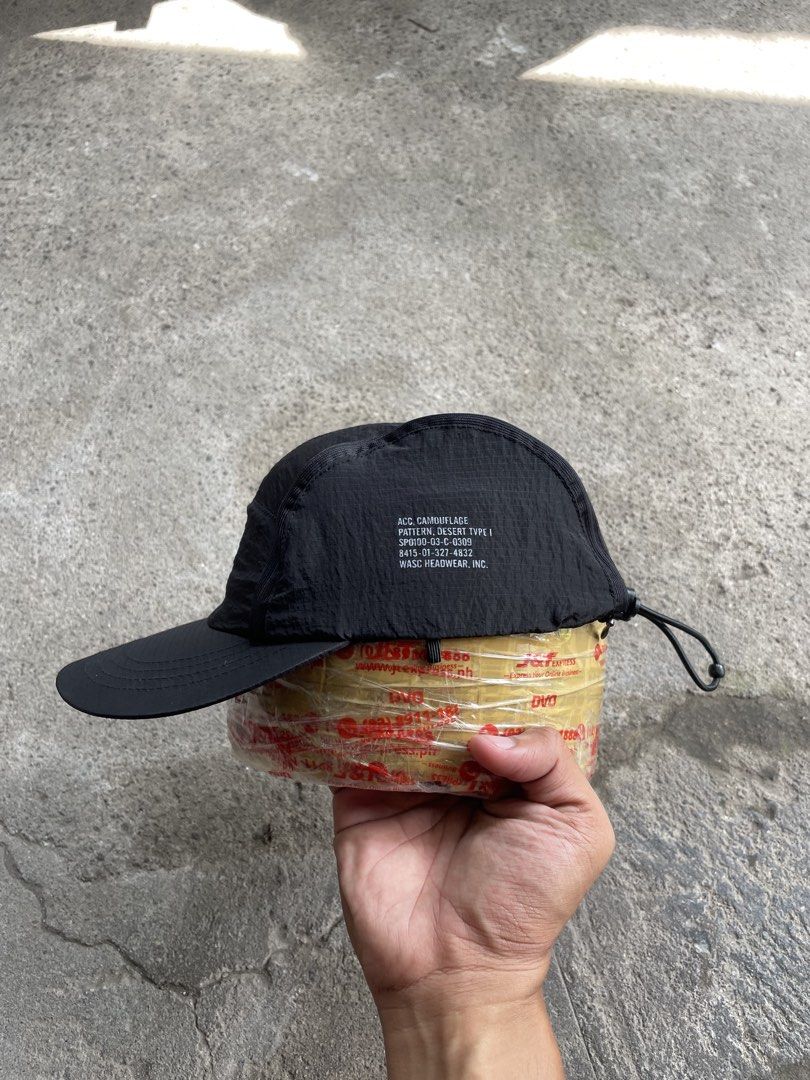 WASC Headwear Black 5-Panel Cap (Category: Caps & Hats) located in General Santos City (Dadiangas). Submitted by christbluee (Listing ID 1468827294, Image 3). Description: - Brand: Wasc Headwear - Style: Black 5-panel cap - Material: Lightweight crinkled nylon - Details: Embroidered mountain logo on front, utility text print on side, metal ventilation eyelets - Closure: Adjustable bungee cord with toggle - Condition: Clean overall.
