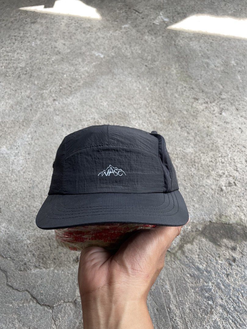 WASC Headwear Black 5-Panel Cap (Category: Caps & Hats) located in General Santos City (Dadiangas). Submitted by christbluee (Listing ID 1468827294, Image 1). Description: - Brand: Wasc Headwear - Style: Black 5-panel cap - Material: Lightweight crinkled nylon - Details: Embroidered mountain logo on front, utility text print on side, metal ventilation eyelets - Closure: Adjustable bungee cord with toggle - Condition: Clean overall.
