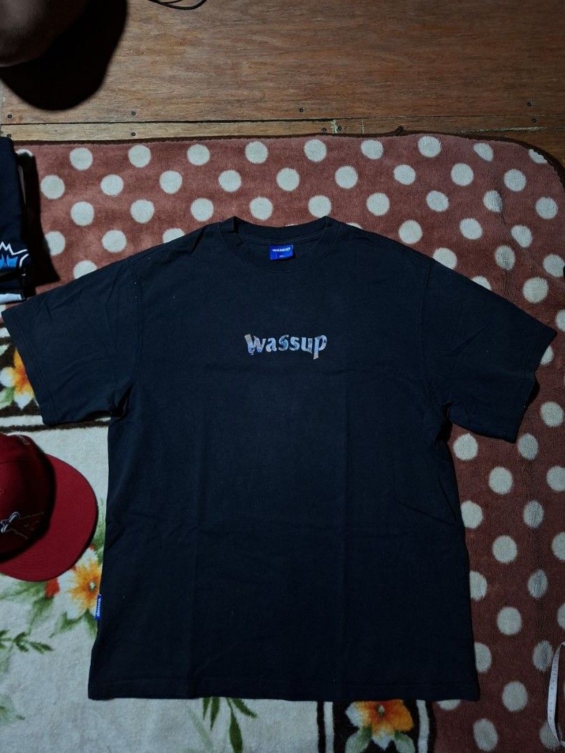 Wassup Black World Map Graphic Tee Size 3XL (Category: Tshirts & Polo Shirts ) located in Rizal. Submitted by thrifthings_10 (Listing ID 1468880683, Image 1). Description: - Size: 3XL (Relaxed oversized fit) - Color: Black - Design: Small 'Wassup' chest print, large colorful world map back print - Details: Blue brand tags on collar interior and lower right hem - Style: Short sleeves, crew neck -Condition: Good fading .