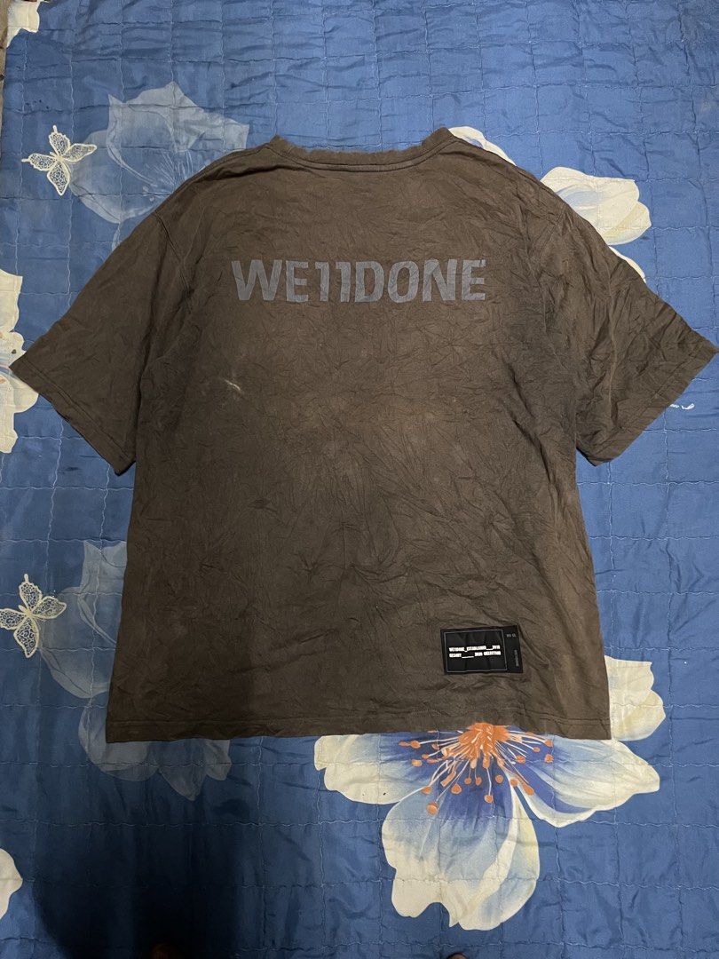 We11done Collage Graphic T-Shirt Brown (Category: Tshirts & Polo Shirts ) located in Manila. Submitted by chawmichael (Listing ID 1468879572, Image 3). Description: - Brand: We11done - Color/Style: Washed brown with vintage dye effect - Design: Large retro movie and pin-up collage print on front - Branding: Big 'WE11DONE' print across upper back and small woven label near lower hem - Fit: Crew neck with relaxed short sleeves - Condition: Excellen