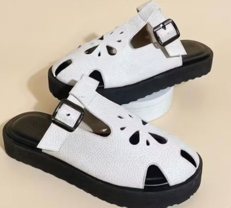 White / Beige Kendra Sandals (RF dupe) (Category: Flats & Sandals) located in Cavite. Submitted by chbii03 (Listing ID 1468789820, Image 2). Description: - Color: White upper with contrast thick black platform soles - Design: Cute cutout flower details on top with a slip-on mule style - Fit: Adjustable side buckle straps for a secure fit - Comfort: Very comfortable for all-day wear - Styling: Easy to style with or without socks RFS: Too big. My f