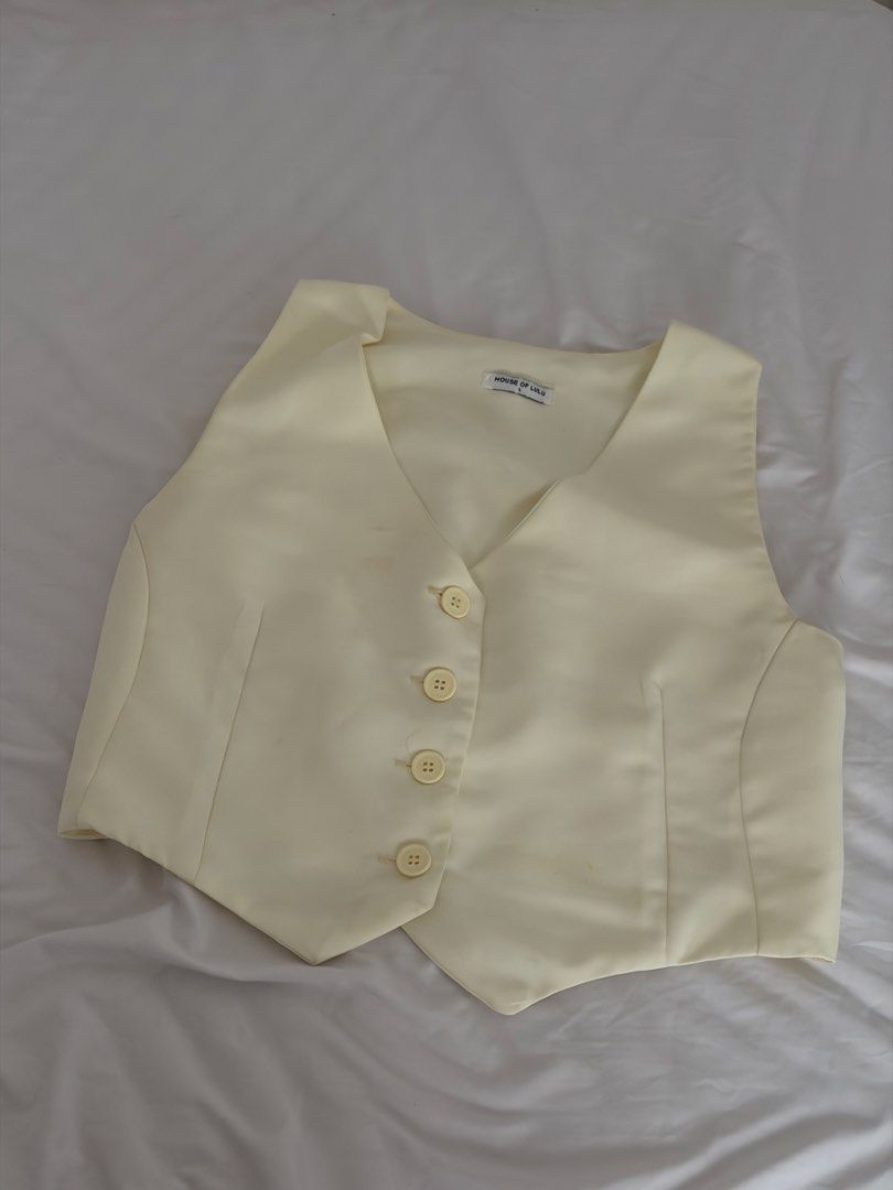 White / Cream Vest Size L (Category: Sleeveless) located in Las Pinas. Submitted by thriftedfinds_ (Listing ID 1468868324, Image 1). Description: - Brand: House of Lulu - Color: Cream - Size: Large - V-neck design with 4 front buttons - Tailored seams for a flattering fit - Adjustable back strap with metal buckle - Clean fabric throughout.