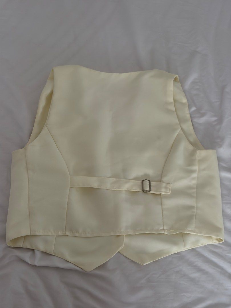 White / Cream Vest Size L (Category: Sleeveless) located in Las Pinas. Submitted by thriftedfinds_ (Listing ID 1468868324, Image 3). Description: - Brand: House of Lulu - Color: Cream - Size: Large - V-neck design with 4 front buttons - Tailored seams for a flattering fit - Adjustable back strap with metal buckle - Clean fabric throughout.