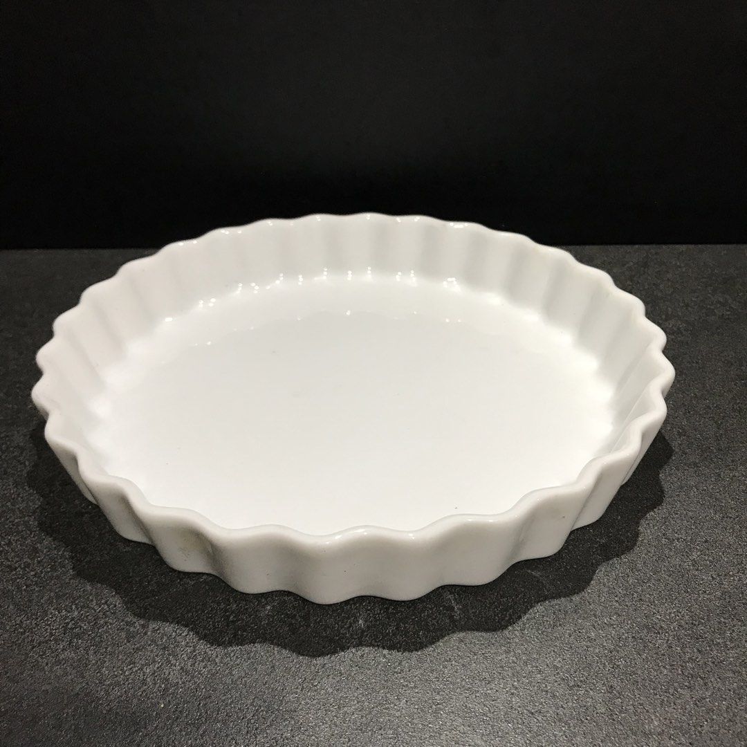 White Ceramic Fluted Tart Pan Quiche Dish (Category: Bakeware) located in Baao. Submitted by all.things.japan (Listing ID 1468746188, Image 1). Description: 9.0 x 1.0 inches - Material: White ceramic with smooth, easy-to-wash glaze - Design: Classic round shape with elegant fluted edges - Ideal for: Baking quiches, tarts, and small pies - Storage: Well-kept and stored in a clean kitchen cabinet.