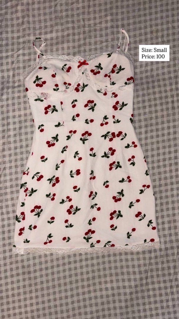 White cherry print spaghetti strap mini dress (Category: Dresses) located in Quezon City. Submitted by analiza_venigas1247 (Listing ID 1468876900, Image 1). Description: - Style: White mini dress with adorable red cherry print - Details: Sweetheart neckline, thin adjustable straps, and sweet red bow at the bust - Trim: Delicate white lace along the neckline and bottom hem - Size: Small - Condition: Brand new / Excellent.