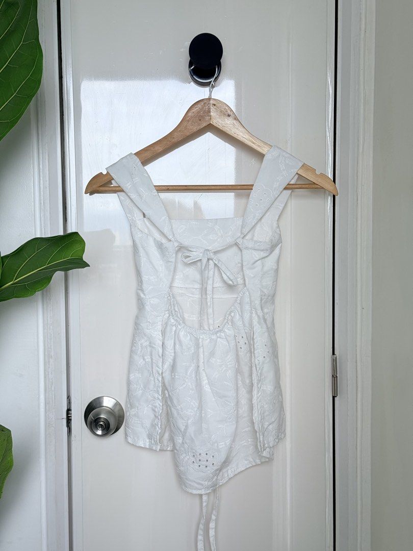 White Eyelet Open Back Tie Top (Category: Sleeveless) located in Quezon City. Submitted by ynnapenyaranda (Listing ID 1468867312, Image 2). Description: - Style: White eyelet top with all-over floral embroidery - Design: Square neckline, wide straps, and open back with tie closure - Details: Gathered hem with bottom tie strings - Fabric: Lightweight and breathable, ideal for warm weather.