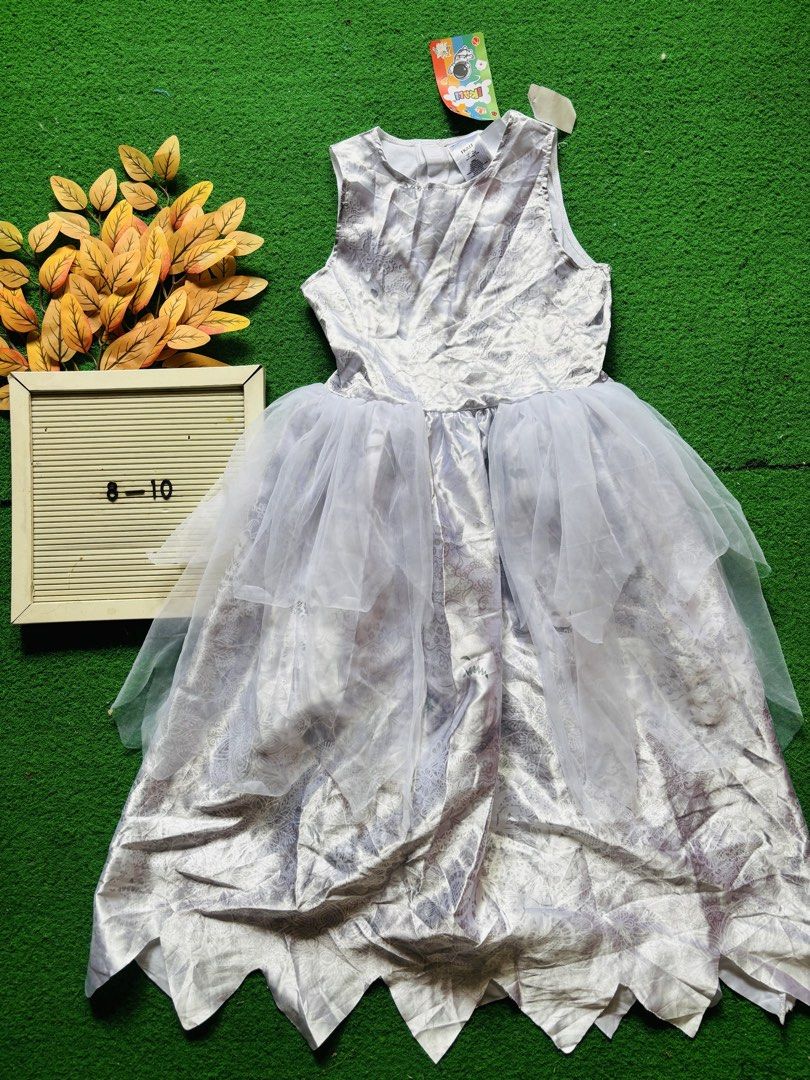 white halloween Costume Size 8-10 (Category: Babies & Kids Fashion) located in San Mateo. Submitted by ariakid47 (Listing ID 1468927652, Image 1). Description: - Condition: Brand new with tags attached - Size: 8-10 - Design: Silver sleeveless top with a unique patterned fabric - Skirt: Layered white tulle skirt overlay with an edgy jagged hemline - Style: Chic, fun, and perfect for parties or events.