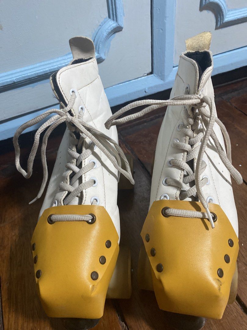 White quad roller skates with yellow toe guards and strap (Category: Skates, Rollerblades & Scooters) located in Caloocan City. Submitted by gii_i (Listing ID 1468821383, Image 2). Description: - Classic white quad skates with mustard toe caps - Includes a matching carrying strap for easy transport - Wheels rolls well, although in need of oiling -Skates are from Squad Skates - Note!!!: Shows noticeable wear around the collar lining and leather up