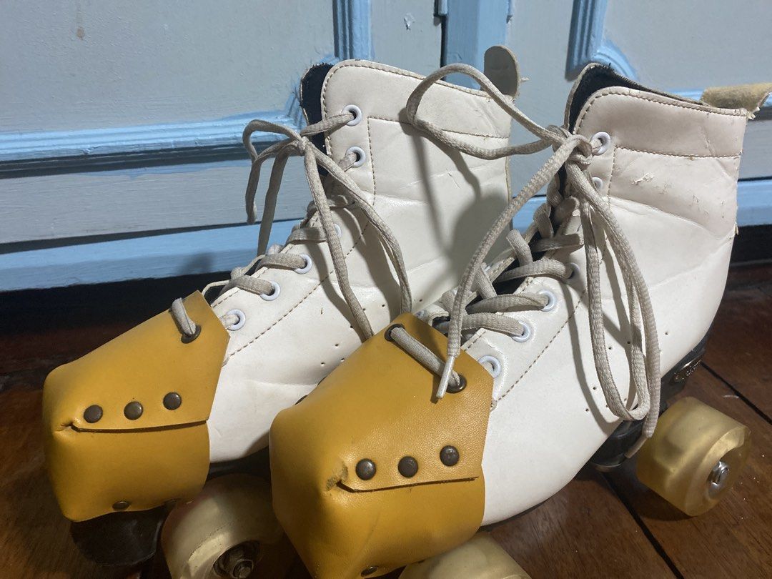 White quad roller skates with yellow toe guards and strap (Category: Skates, Rollerblades & Scooters) located in Caloocan City. Submitted by gii_i (Listing ID 1468821383, Image 1). Description: - Classic white quad skates with mustard toe caps - Includes a matching carrying strap for easy transport - Wheels rolls well, although in need of oiling -Skates are from Squad Skates - Note!!!: Shows noticeable wear around the collar lining and leather up