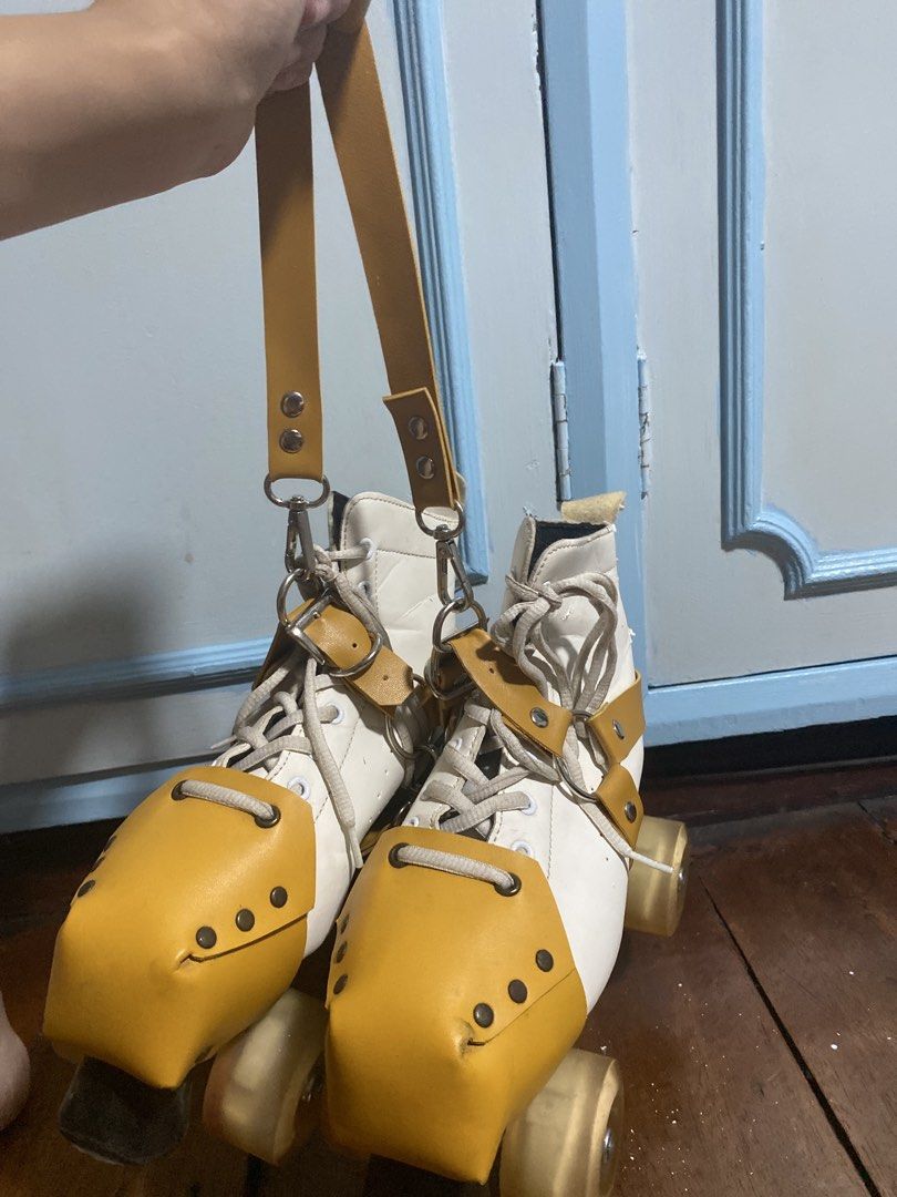 White quad roller skates with yellow toe guards and strap (Category: Skates, Rollerblades & Scooters) located in Caloocan City. Submitted by gii_i (Listing ID 1468821383, Image 3). Description: - Classic white quad skates with mustard toe caps - Includes a matching carrying strap for easy transport - Wheels rolls well, although in need of oiling -Skates are from Squad Skates - Note!!!: Shows noticeable wear around the collar lining and leather up