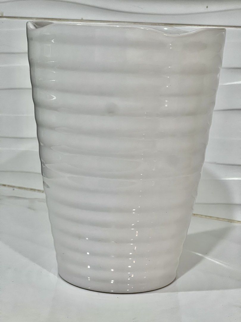 White Ribbed Ceramic Flower Vase (Category: Vases & Decorative Bowls) located in Pateros City. Submitted by mcacompany (Listing ID 1468888290, Image 3). Description: - Material: White ceramic with a glossy finish - Design: Horizontal ribbed texture and unique wavy rim - Shape: Tapered cylindrical silhouette - Versatile: Looks great with any flowers or displayed on its own - Perfect for living rooms, bedrooms, or tabletops Find many great new & us