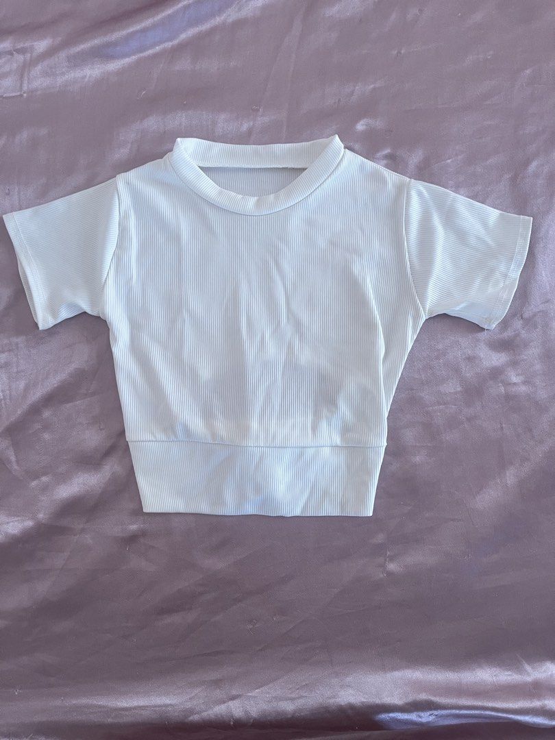 White Ribbed Knit Short Sleeve Open Back Crop Top (Category: Shirts) located in Manila. Submitted by lovedbymidge (Listing ID 1468869893, Image 1). Description: 🩷 for xs-s girlies (worn twice, in good condition) 🚚 lalamove or grab express (sf shouldered by the buyer!) - Color/Pattern: Solid white - Material: Stretchy ribbed knit, super comfortable - Design: Short sleeves, round neckline, open back cutout with tie-bow detail.