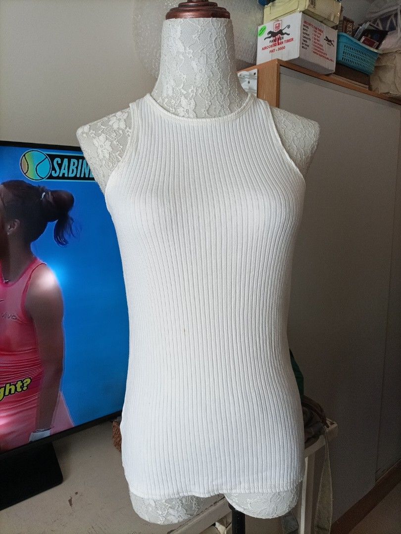 White Ribbed Tank Top with Bra Strap Holder (Category: Sleeveless) located in Pasig City. Submitted by sandacecloset (Listing ID 1468774161, Image 2). Description: - Color: White - Style: Ribbed tank top - Fit: Soft and stretchy, hugs the body closely - Feature: Built-in fabric loop to keep bra straps securely in place - Design: Clean edges for a versatile everyday basic.