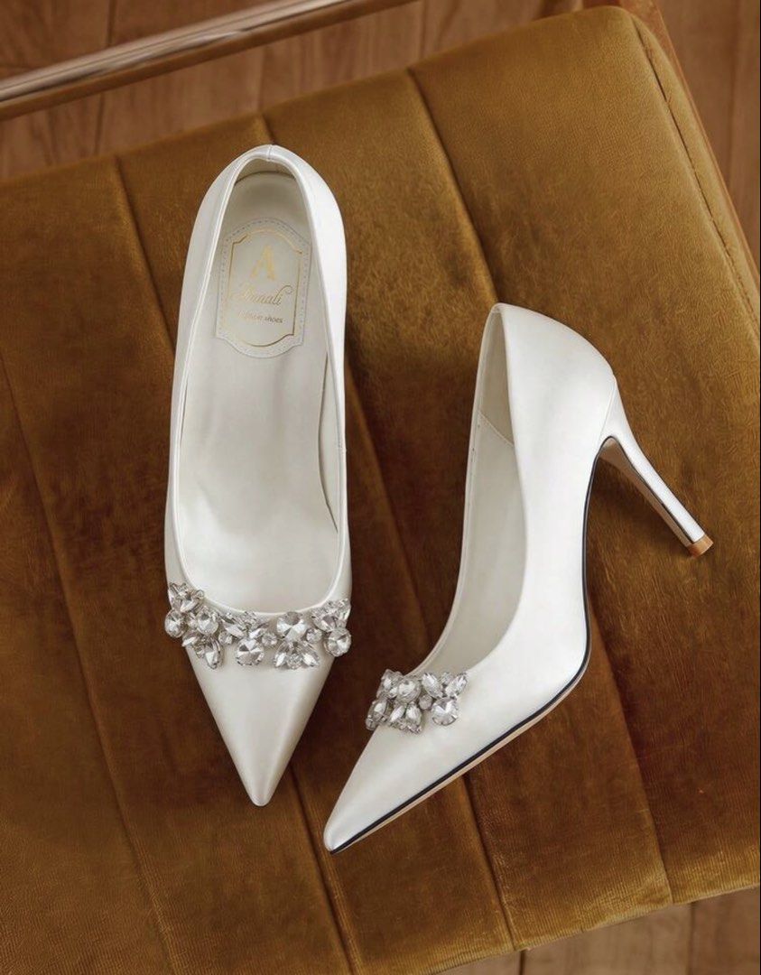 White Satin Pointed Toe Heels with Crystal Brooch (Category: Heels) located in Santo Tomas. Submitted by kylejao21 (Listing ID 1468877931, Image 2). Description: - Elegant white satin pumps with a smooth finish - Stylish pointed toe design with dazzling crystal embellishments - Classic stiletto heels for an elevated, sophisticated look - Clean interior lining featuring a chic gold stamped logo - Ideal for weddings, debuts, parties, and formal eve