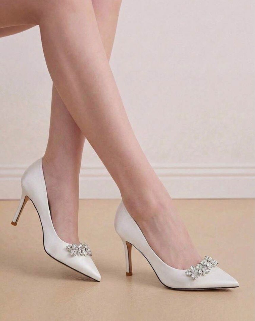 White Satin Pointed Toe Heels with Crystal Brooch (Category: Heels) located in Santo Tomas. Submitted by kylejao21 (Listing ID 1468877931, Image 3). Description: - Elegant white satin pumps with a smooth finish - Stylish pointed toe design with dazzling crystal embellishments - Classic stiletto heels for an elevated, sophisticated look - Clean interior lining featuring a chic gold stamped logo - Ideal for weddings, debuts, parties, and formal eve