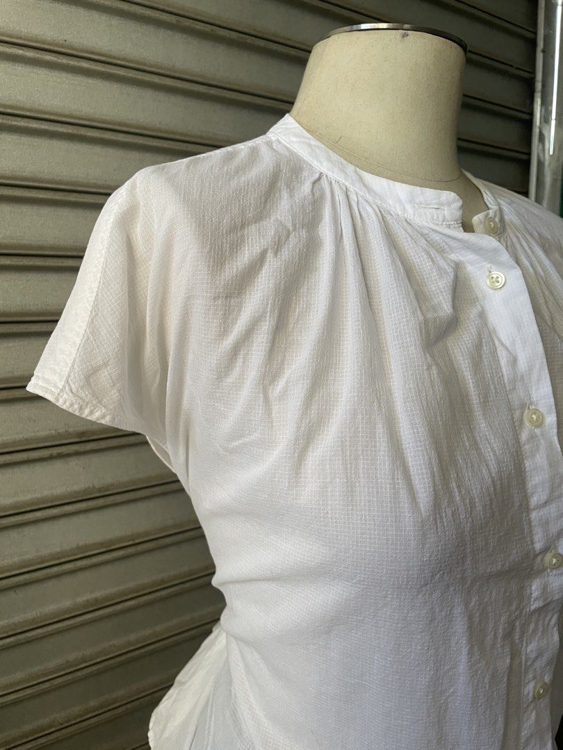 White Short Sleeve Button-Up Blouse (Category: Blouses) located in Davao. Submitted by riab_qt (Listing ID 1468777637, Image 3). Description: - Color: Crisp white - Size: M-L - Design: Mandarin collar, button-down front, and subtle gathered pleats - Fabric: Lightweight checkered textured material - Style: Versatile basic staple, great with skirts or trousers for casual or smart-casual looks.