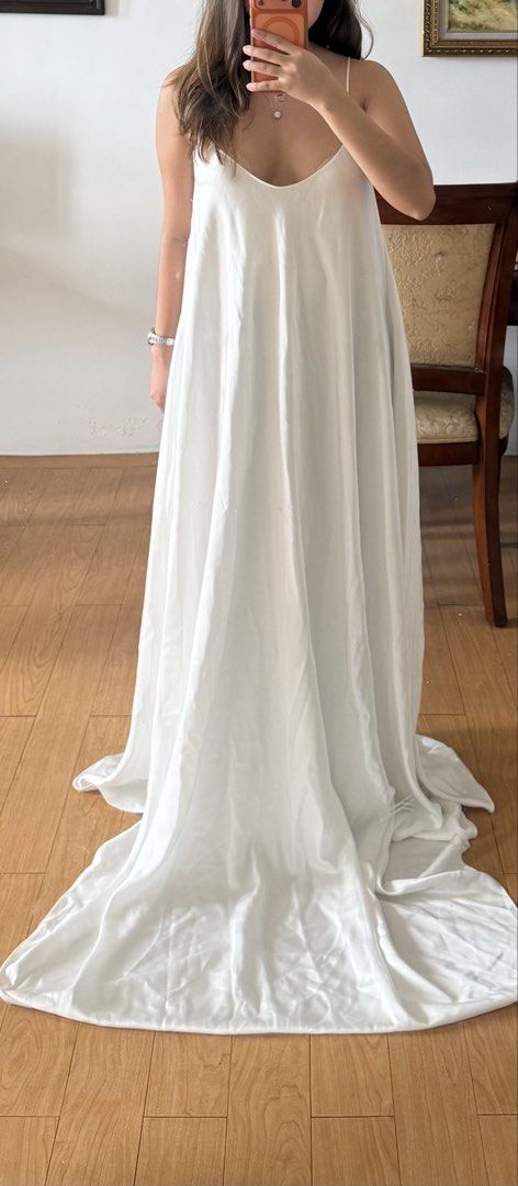 White silk Long Dress With Slit Back (Category: Dresses) located in Manila. Submitted by expectopatronum934 (Listing ID 1468768884, Image 1). Description: - Color: White - Material: Smooth satin-like fabric with a subtle sheen - Design: Minimalist and sleek - Neckline: V-neck in the front -rfs: too long for me.