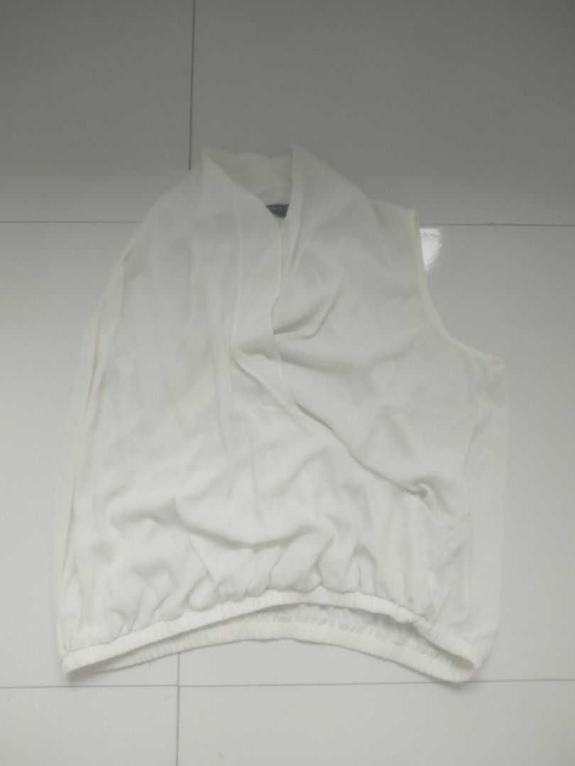 White Sleeveless Drape Neck Blouse (Category: Sleeveless) located in Manila. Submitted by gentlephoenix.339381 (Listing ID 1468740815, Image 1). Description: - Color: White - Style: Sleeveless top with a chic draped neckline and gathered elastic hem - Material: Lightweight, flowy, and breathable fabric - Fit: Great for pairing with high-waisted jeans or skirts - Condition: Excellent/barely worn, wardrobe staple for warm weather.