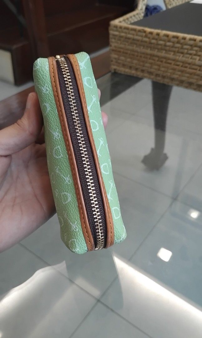 Why Coin Purse (Category: Wallets & Card holders) located in Naga. Submitted by camsss_f (Listing ID 1468747780, Image 3). Description: - Color & Design: Green with white key and lock pattern - Accents: Brown leather-look trim and gold zipper hardware - Interior: Dark brown fabric lining with a branded tag and small attached chain - Condition: Clean inside and out, smoke-free home - Use: Handy pouch for organizing small items in your everyday bag