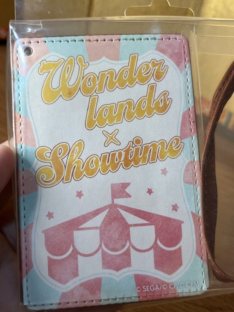 Wonderlands x Showtime ID Card Case / Pass Case Project Sekai (Category: Wallets & Card holders) located in Gapan. Submitted by lunashop14 (Listing ID 1468716542, Image 2). Description: 2 pcs available sealed - Official SEGA Project Sekai merchandise - Wonderlands x Showtime circus-themed design with pastel stripes - Includes brown leatherette card holder, matching strap, and retractable reel - Brand new and still inside original plastic packagin