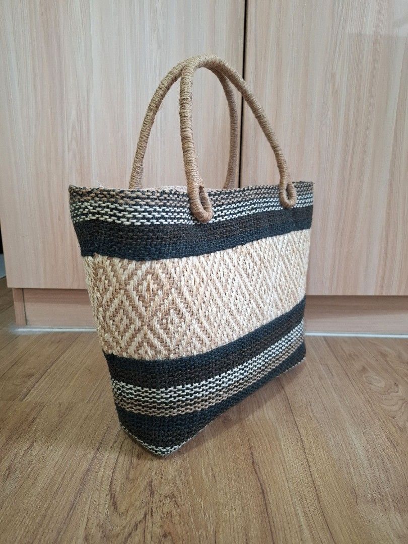 Woven Straw Tote Bag with Striped Pattern and Handles (Category: Tote Bags) located in Taguig. Submitted by mary_jeha (Listing ID 1468787863, Image 2). Description: Woven Tote Bag with Zipper Material: Woven straw with stylish black, brown, and beige stripes in a geometric diamond pattern. Has fabric inner lining. Handles: Dual twisted rope handles for a comfortable and secure grip - spacious interior - ideal for everyday use, shopping, or beach 