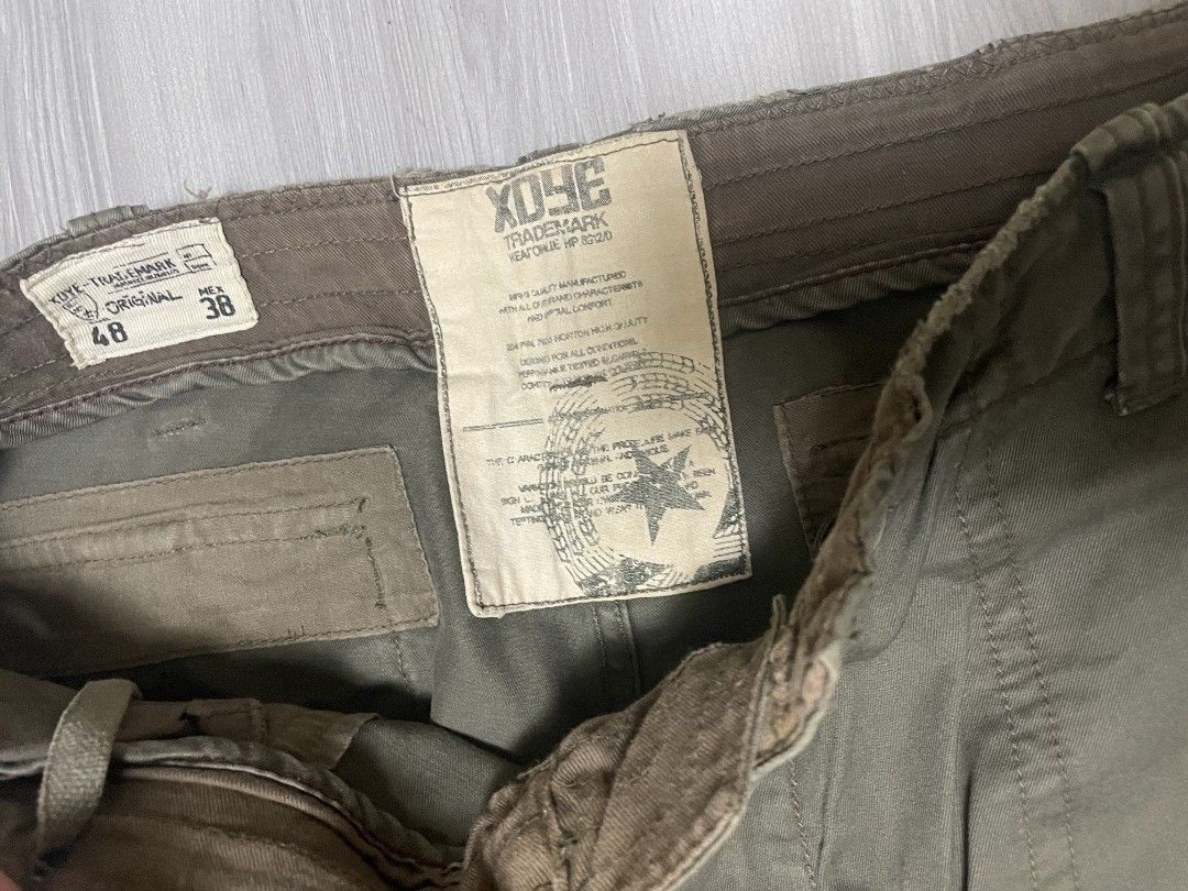 Xoye Cargo Pants Green Size 38 (Category: Jeans) located in Lipa City. Submitted by t1pce3garmentz (Listing ID 1468730905, Image 2). Description: - Brand: Xoye - Size: 38 - Color: Green - Style: Casual streetwear cargo pants - Features: Multiple utility pockets, drawstring waist, and adjustable leg cuffs.