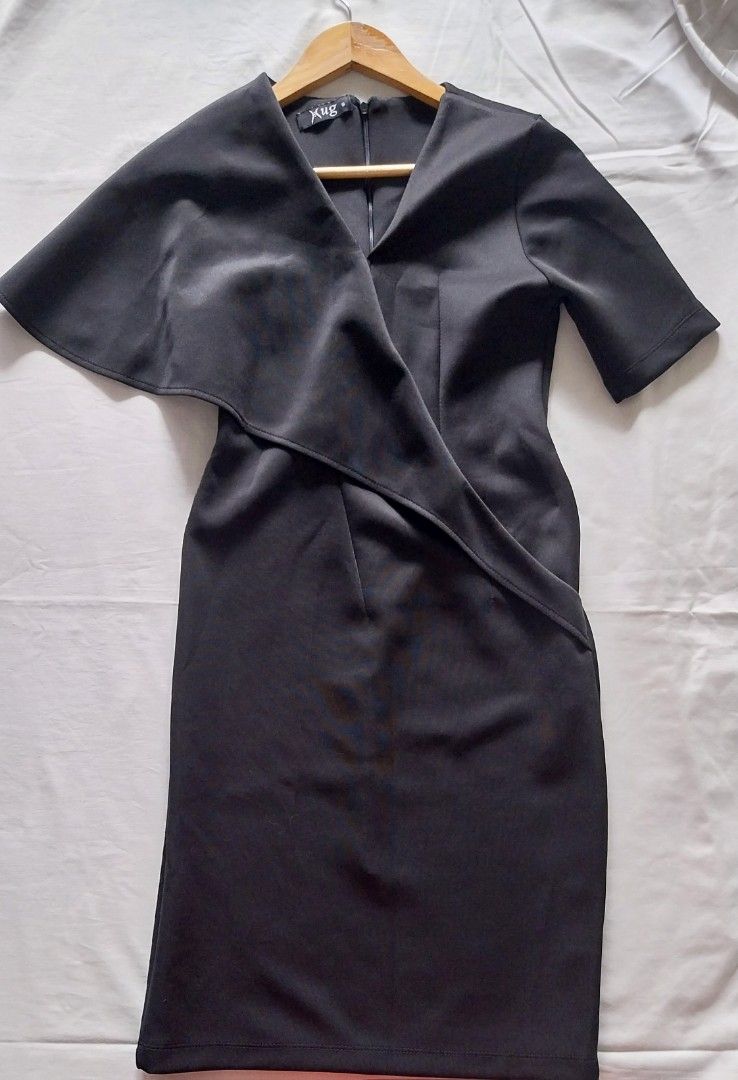 Xug Black Cape Dress Size S (Category: Dresses) located in Makati City. Submitted by everythingp100 (Listing ID 1468781986, Image 1). Description: - Brand: Xug - Size: Small - Color: Solid black - Design: V-neck wrap front with elegant cape overlay on shoulders and back - Closure & Fit: Back zipper closure with a small slit at the hem - Condition: Clean and well-maintained.