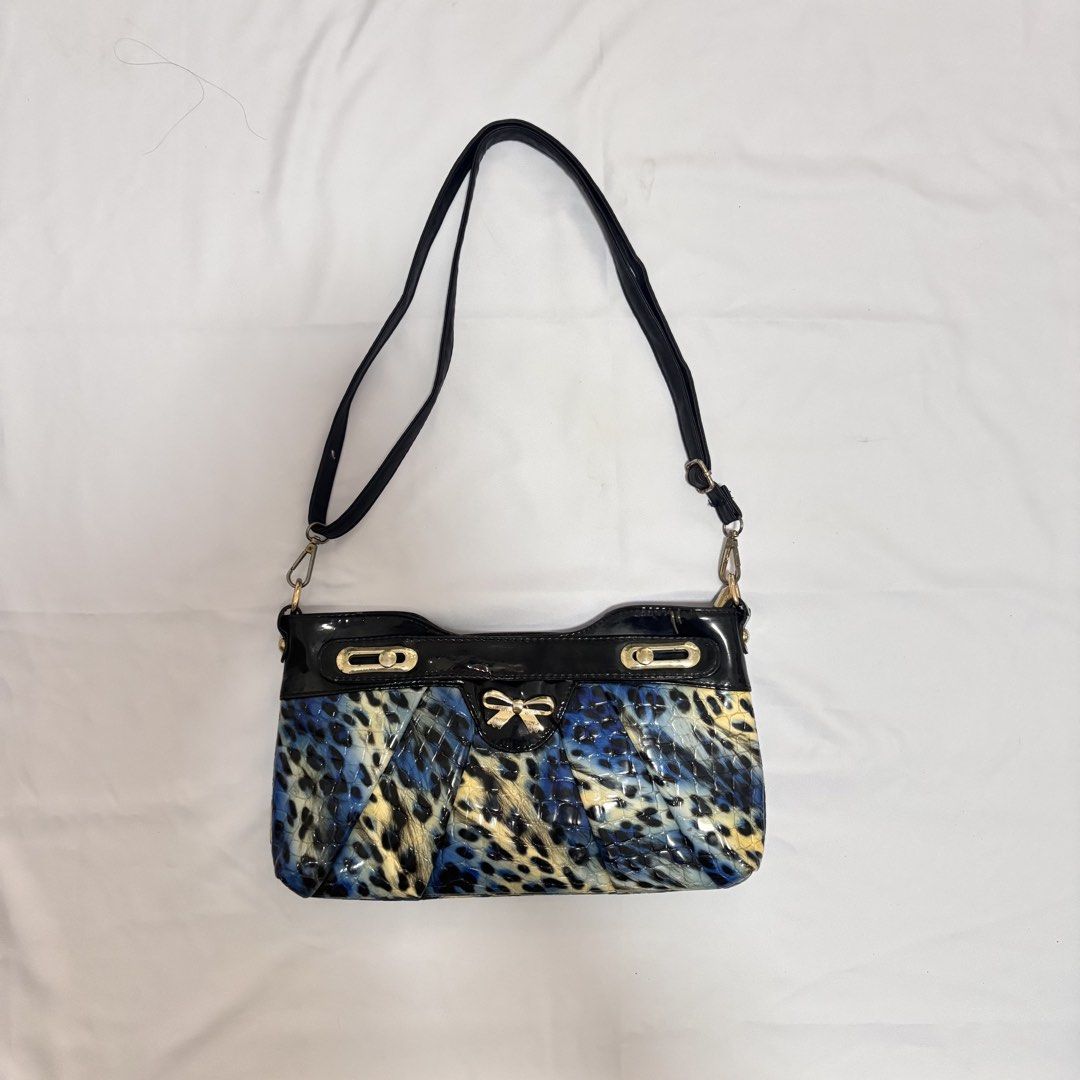 Y2K Leopard Print Shoulder Bag (Category: Shoulder Bags) located in Imus. Submitted by wear.arca (Listing ID 1468825387, Image 1). Description: - So cute and print is sooo nice - Eye-catching blue and black animal print with a glossy finish - Elegant gold-tone hardware and decorative front bow - Structured bottom with trendy pleated paneling.