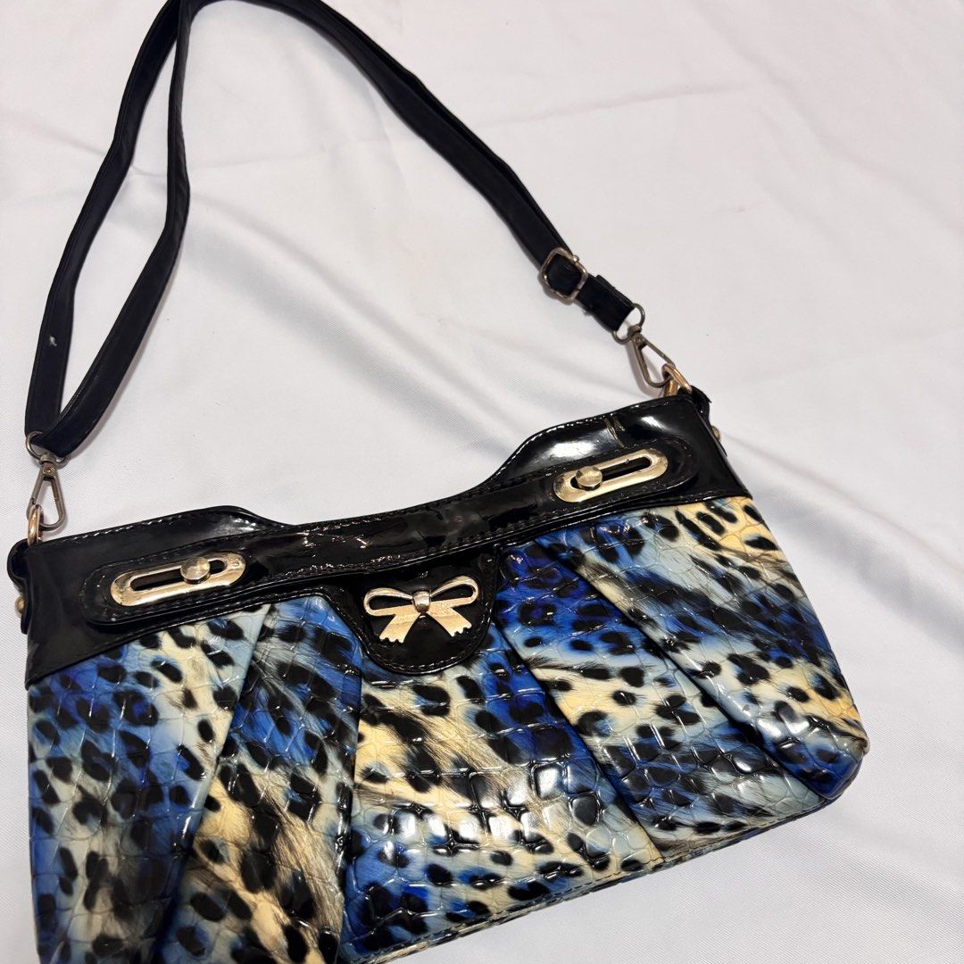 Y2K Leopard Print Shoulder Bag (Category: Shoulder Bags) located in Imus. Submitted by wear.arca (Listing ID 1468825387, Image 2). Description: - So cute and print is sooo nice - Eye-catching blue and black animal print with a glossy finish - Elegant gold-tone hardware and decorative front bow - Structured bottom with trendy pleated paneling.